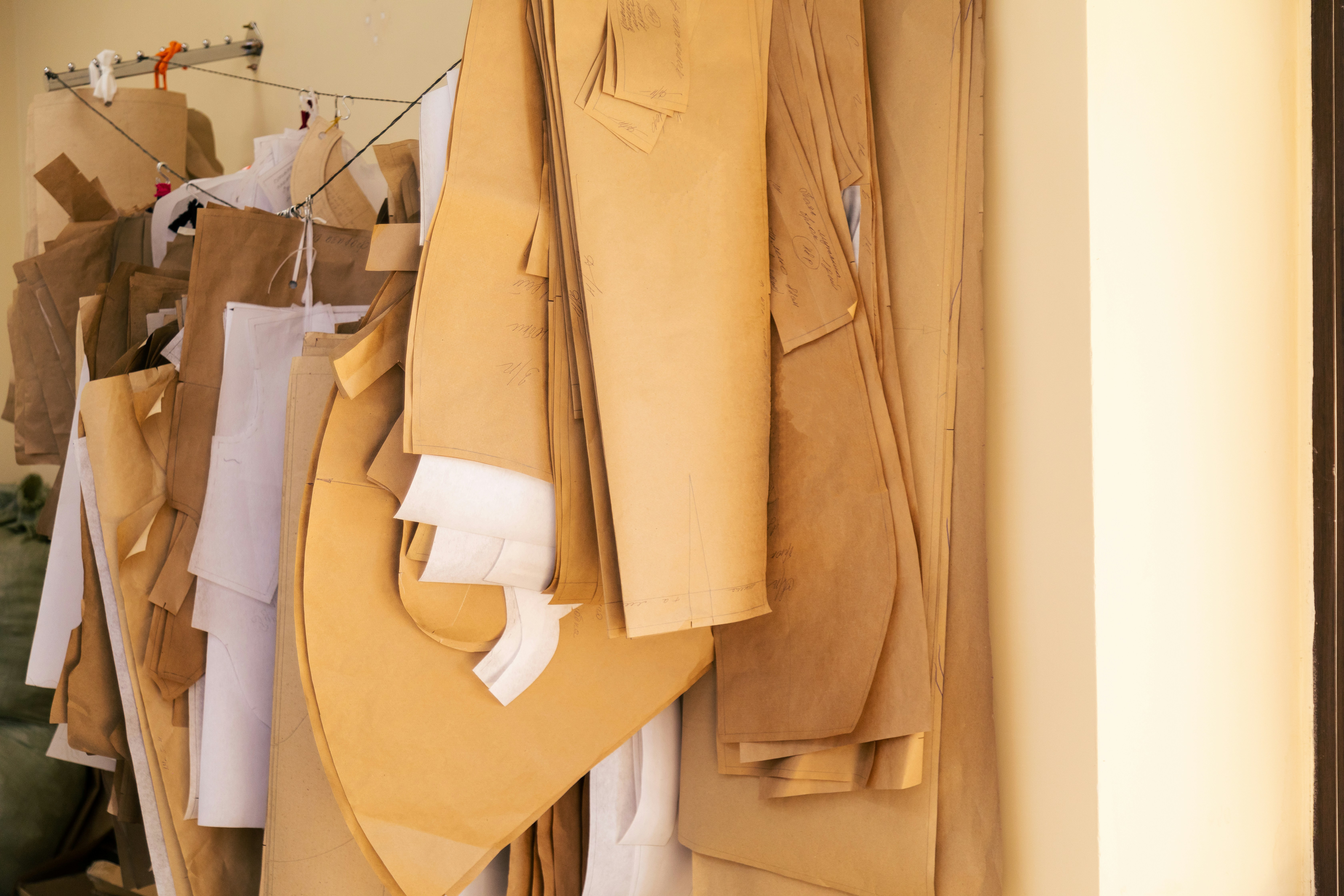 Paper patterns and toile hanging in the workshop.